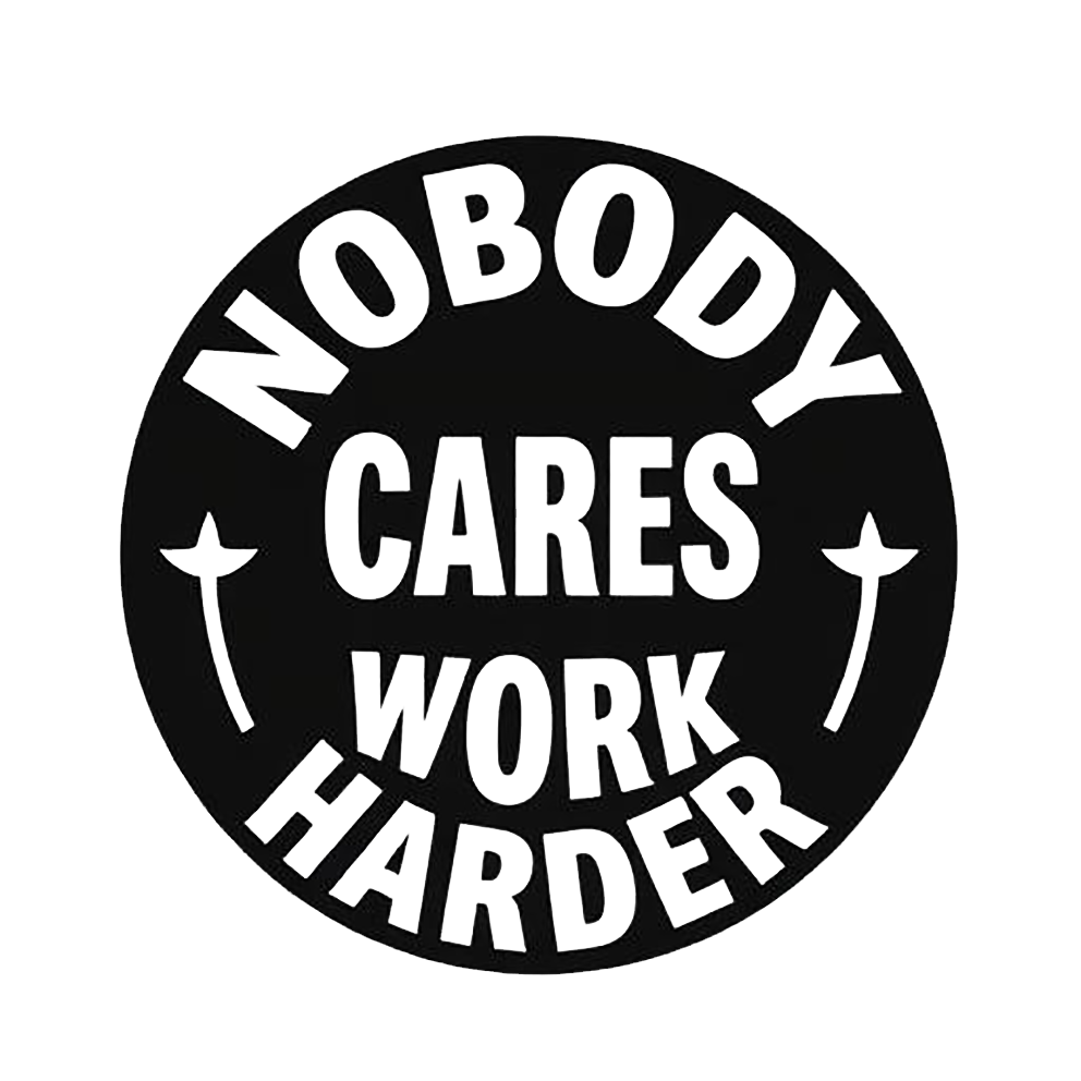 Black circular decal with bold white text reading “Nobody Cares, Work Harder,” surrounded by small decorative stars.