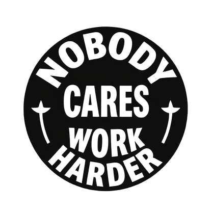 Black circular decal with bold white text reading “Nobody Cares, Work Harder,” surrounded by small decorative stars.