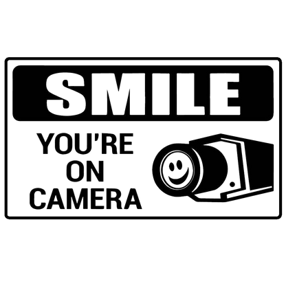Black and white decal reading “Smile, you’re on camera” with a smiling camera illustration.
