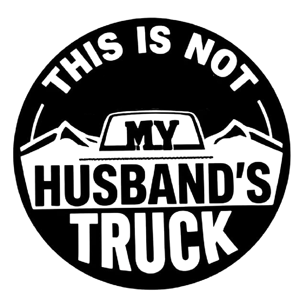 Black and white circular humorous decal featuring mountain graphics and the text “THIS IS NOT MY HUSBAND'S TRUCK.”