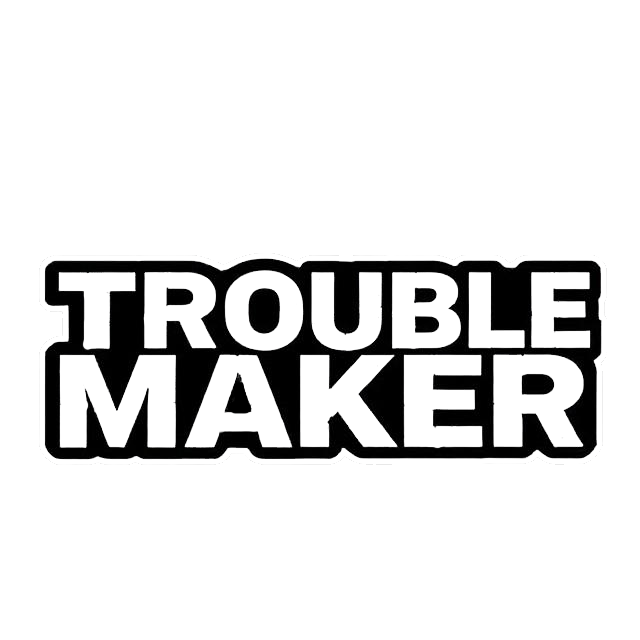 Black and white sticker with bold block lettering that reads “TROUBLE MAKER.”
