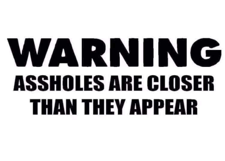 Black-and-white text decal reading, “WARNING ASSHOLES ARE CLOSER THAN THEY APPEAR.”